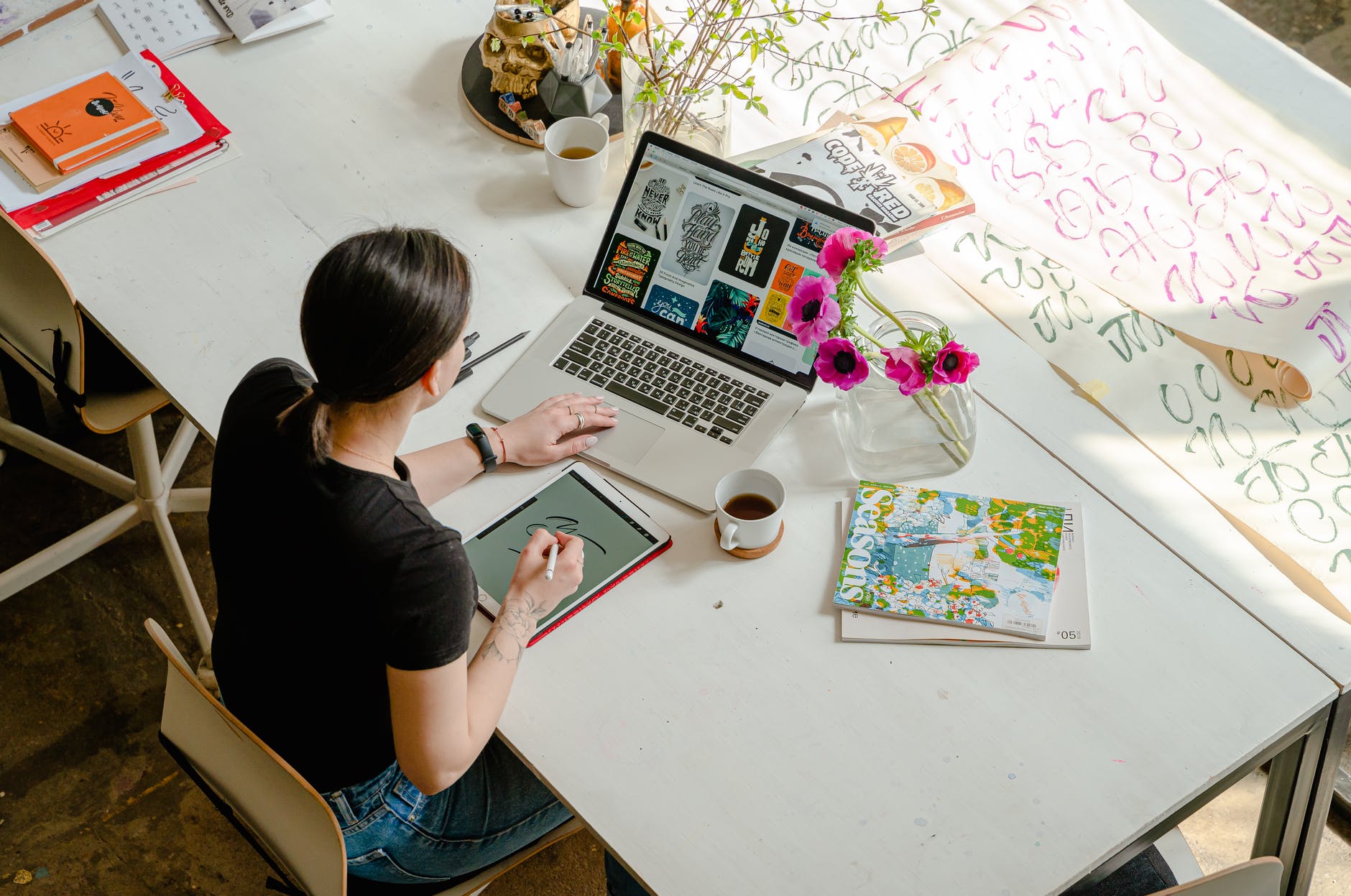 woman in black t shirt using macbook pro