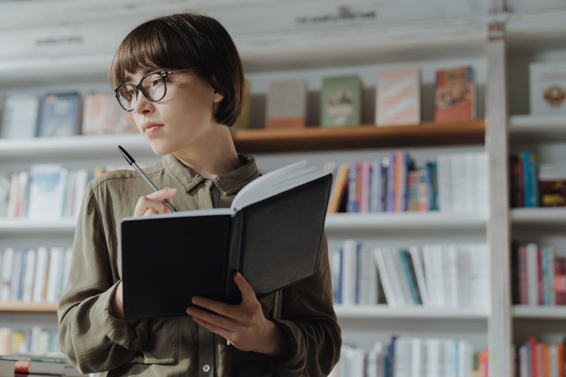 woman in green jacket reading book