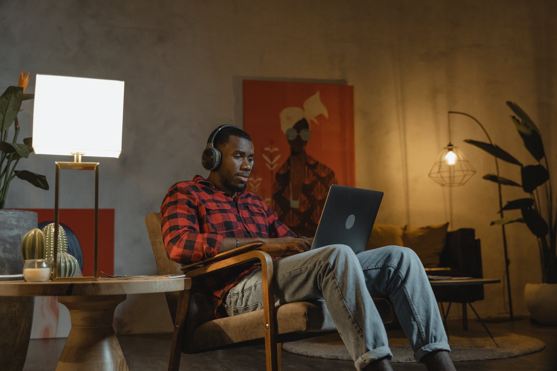 man sitting on an armchair while using his laptop- Remote Working Set-Up