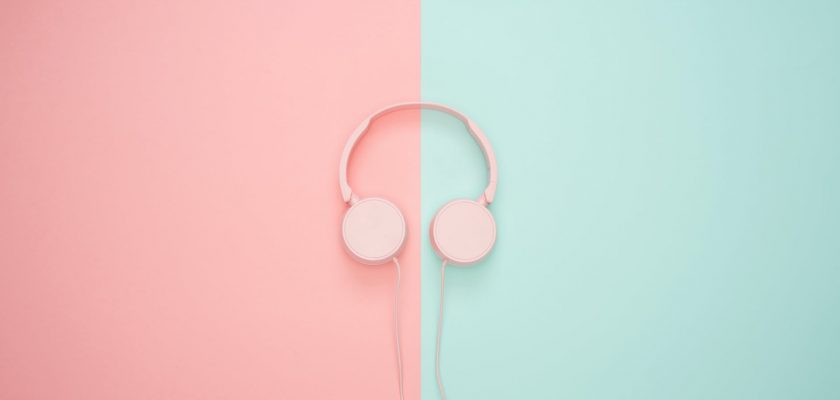 pink corded headphones on pink and teal wall