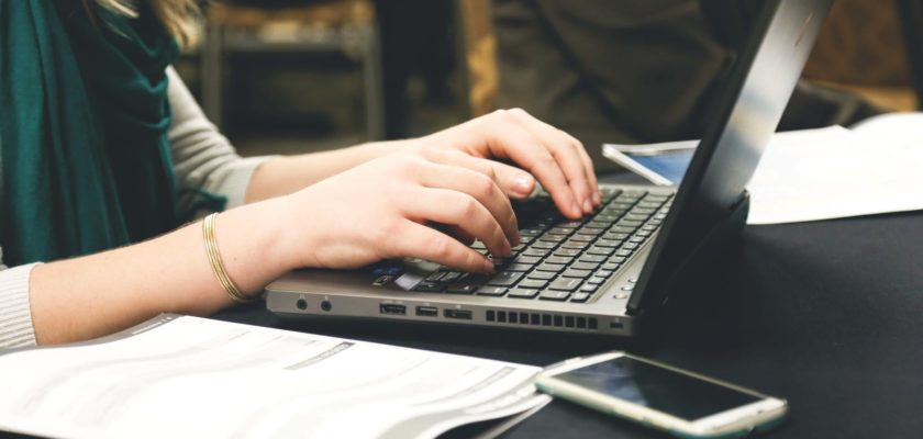 woman typing on laptop