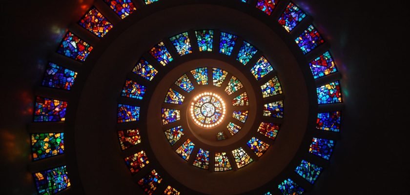 worms eye view of spiral stained glass decors through the roof